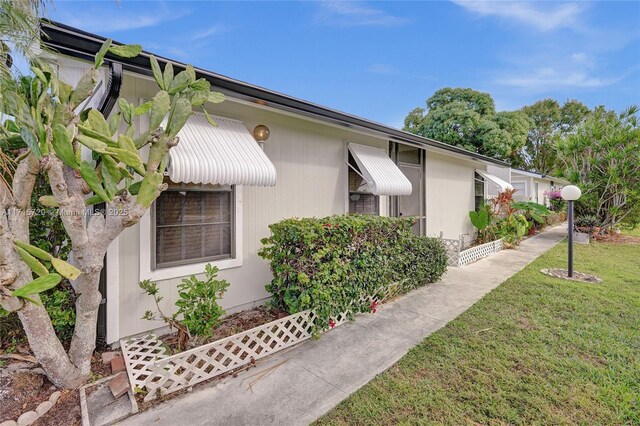 view of property exterior with a yard