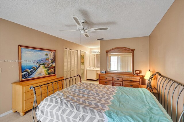 bedroom with connected bathroom, ceiling fan, a closet, and a textured ceiling