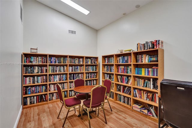 sitting room with wood-type flooring and lofted ceiling