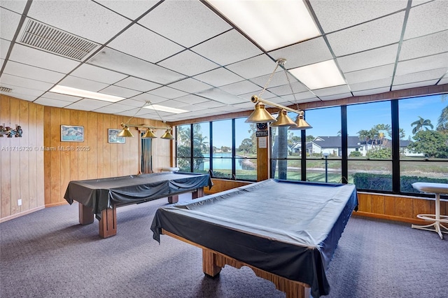 rec room with wooden walls, a drop ceiling, carpet floors, and billiards