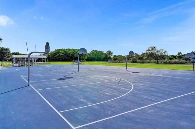 view of sport court with a lawn