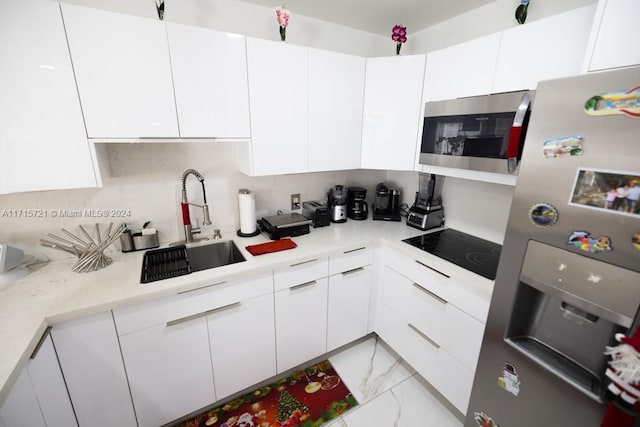 kitchen with white cabinets, sink, and appliances with stainless steel finishes