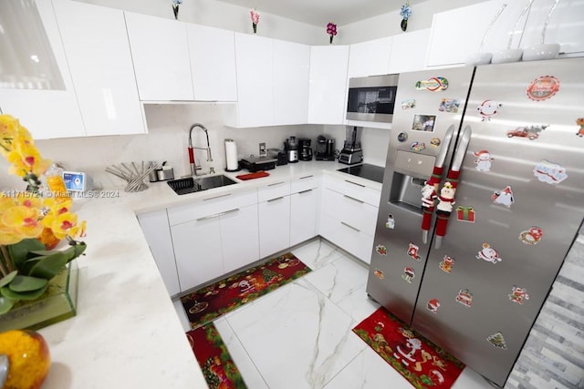 kitchen featuring white cabinetry, sink, and stainless steel appliances