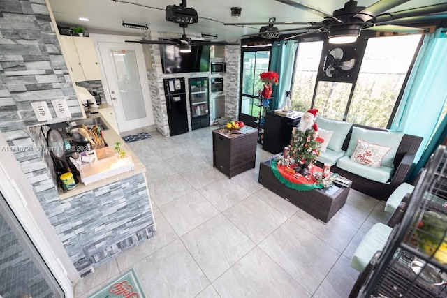 tiled living room featuring ceiling fan