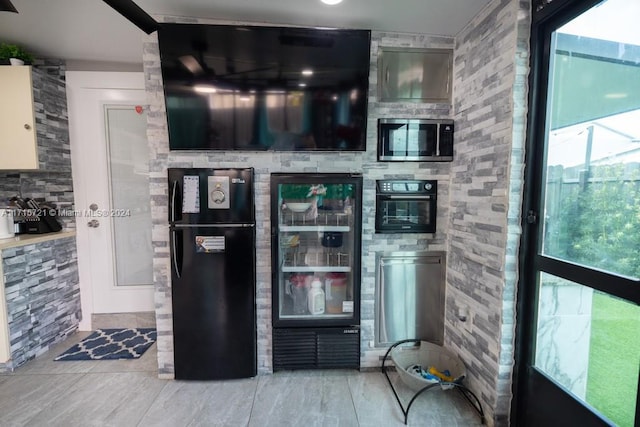 kitchen featuring beverage cooler and black appliances