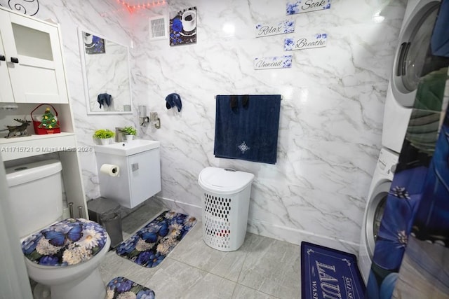 bathroom featuring washer / clothes dryer and toilet