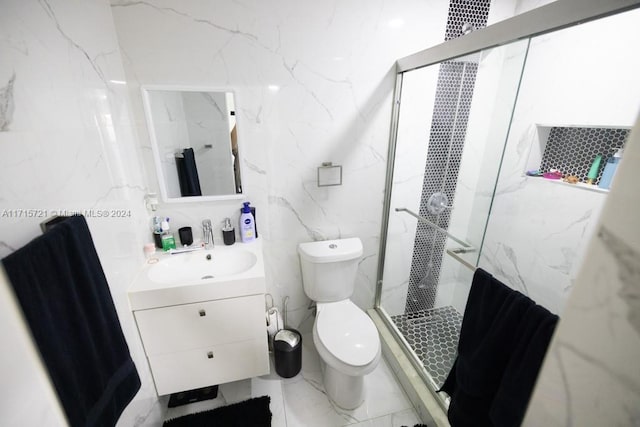 bathroom with a tile shower, vanity, and toilet