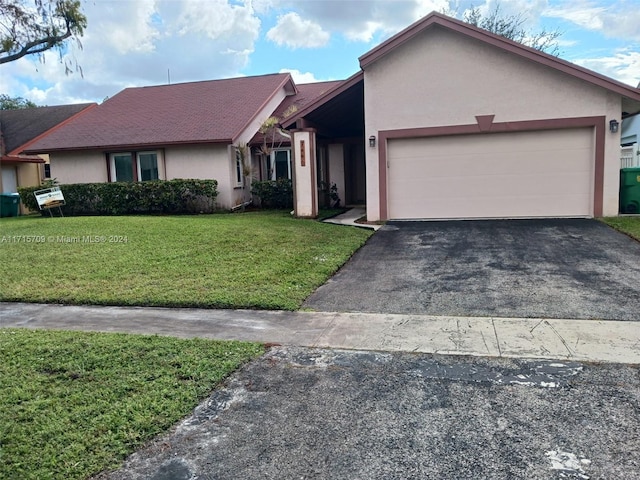 ranch-style home with a garage and a front lawn