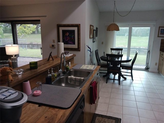 kitchen with dishwashing machine, sink, and light tile patterned flooring