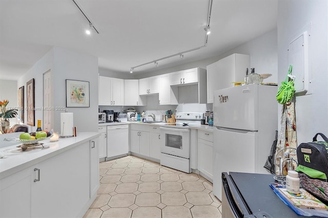 kitchen with white appliances, a sink, light countertops, white cabinets, and track lighting