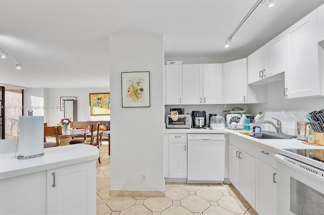 kitchen featuring a sink, white appliances, white cabinetry, and light countertops