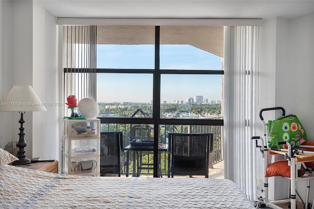 bedroom with a city view and floor to ceiling windows