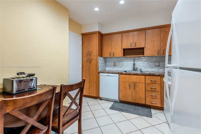 1985 S Ocean Dr Unit 6P, Hallandale Beach, FL 33009 - kitchen featuring white appliances, a sink, tasteful backsplash, brown cabinetry, and light tile patterned floors