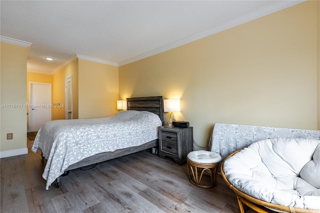 bedroom featuring wood-type flooring and crown molding