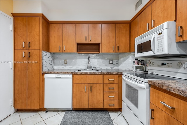 1985 S Ocean Dr Unit 6P, Hallandale Beach, FL 33009 - kitchen with white appliances, a sink, light tile patterned floors, decorative backsplash, and brown cabinets