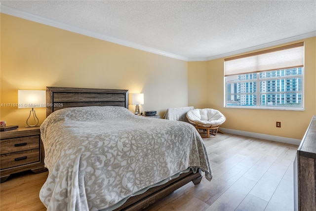 1985 S Ocean Dr Unit 6P, Hallandale Beach, FL 33009 - bedroom with ornamental molding, light wood-style floors, a textured ceiling, and baseboards