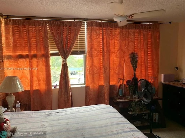 unfurnished bedroom with carpet flooring, ceiling fan, and a textured ceiling