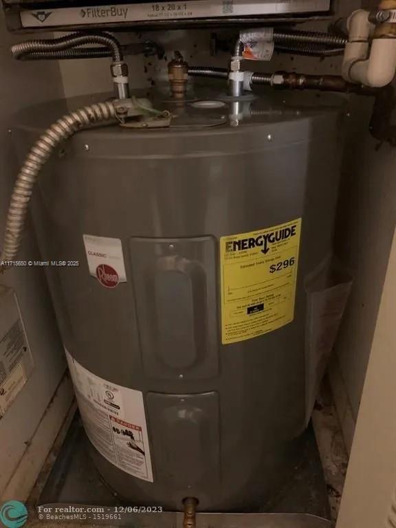 utility room with electric water heater