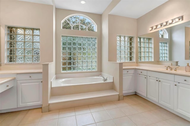 bathroom with vanity, a tub to relax in, and tile patterned floors