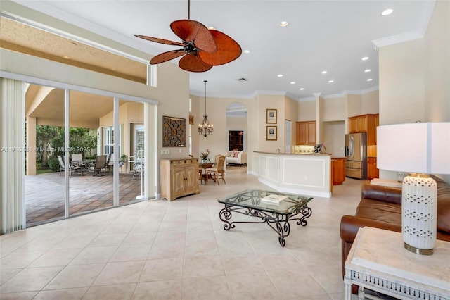 tiled living room featuring ceiling fan with notable chandelier and crown molding