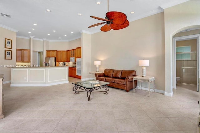 living room featuring light tile patterned floors, ceiling fan, and ornamental molding