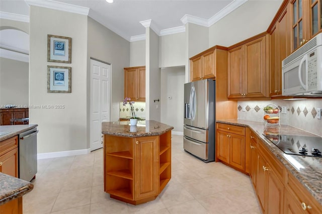 kitchen with tasteful backsplash, stone counters, light tile patterned flooring, and appliances with stainless steel finishes