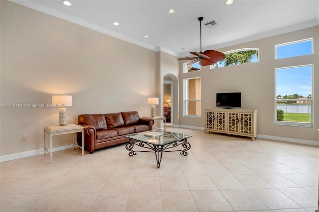 living room featuring crown molding, ceiling fan, and light tile patterned floors