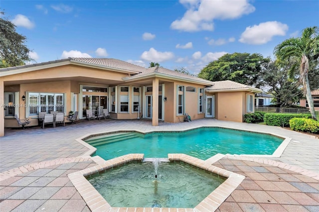 back of property with a patio