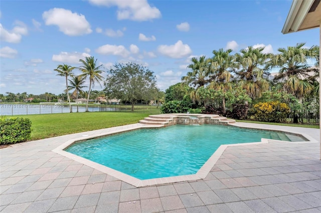 view of pool with a patio area, a water view, a yard, and an in ground hot tub