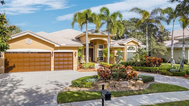 mediterranean / spanish home with a garage