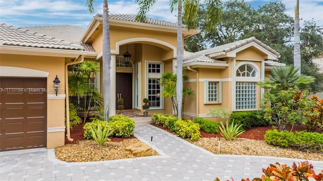 doorway to property with a garage