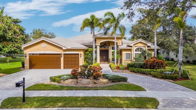 view of front of property with a front lawn and a garage