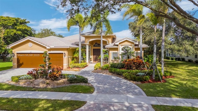 view of front of home with a front lawn and a garage