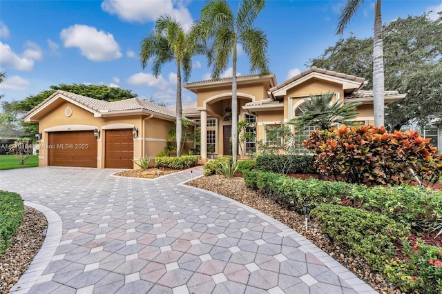 mediterranean / spanish house featuring a garage