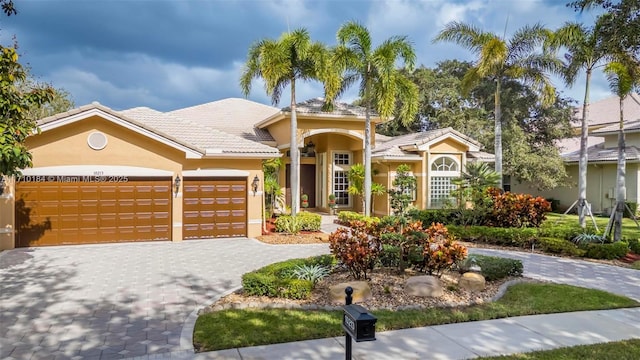 mediterranean / spanish-style house with a garage