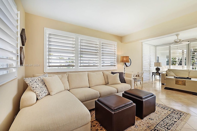 living room featuring light tile patterned floors, plenty of natural light, and ceiling fan