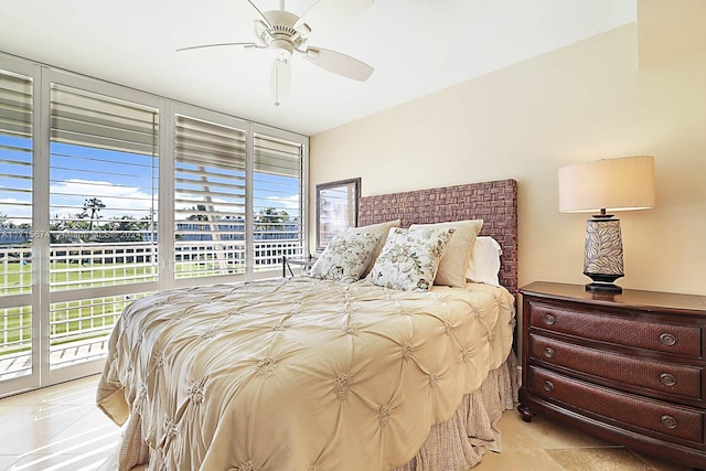 bedroom with access to exterior, multiple windows, and ceiling fan