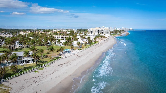 birds eye view of property featuring a water view and a beach view