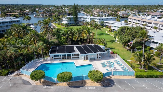 view of swimming pool with a water view and a patio