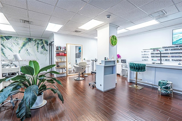 office area with a paneled ceiling