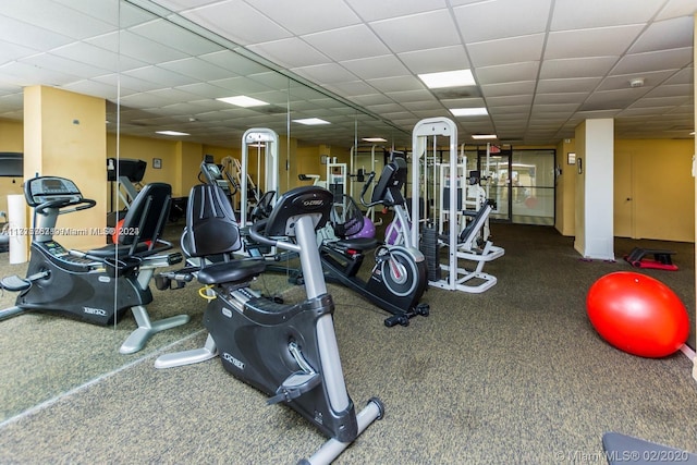 exercise room featuring a drop ceiling