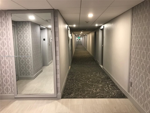 hallway with a drop ceiling