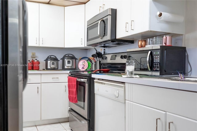 kitchen featuring white cabinets, light tile patterned floors, and appliances with stainless steel finishes