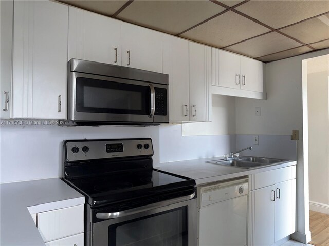 kitchen with white cabinets, light tile patterned floors, and stainless steel refrigerator with ice dispenser