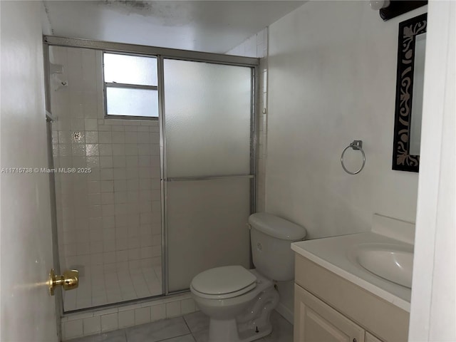 bathroom featuring vanity, a shower stall, toilet, and tile patterned flooring