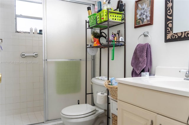 bathroom with vanity, toilet, and an enclosed shower