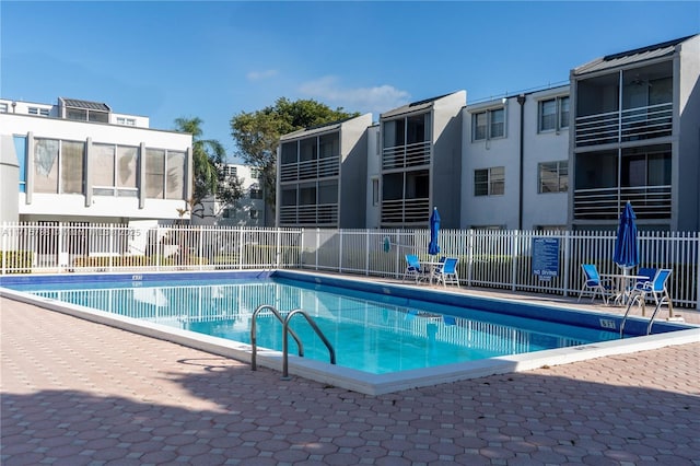 pool with fence and a residential view