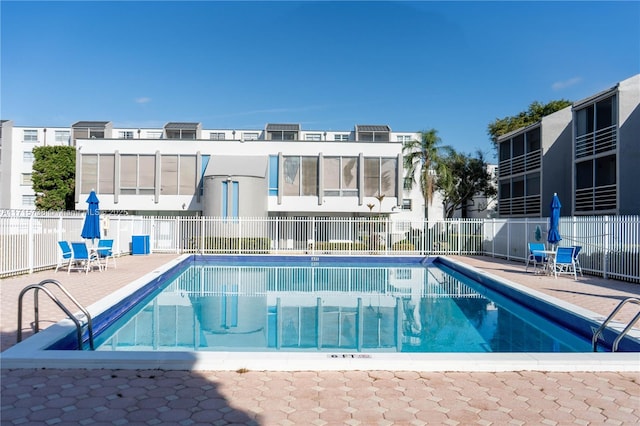 community pool featuring a patio area and fence