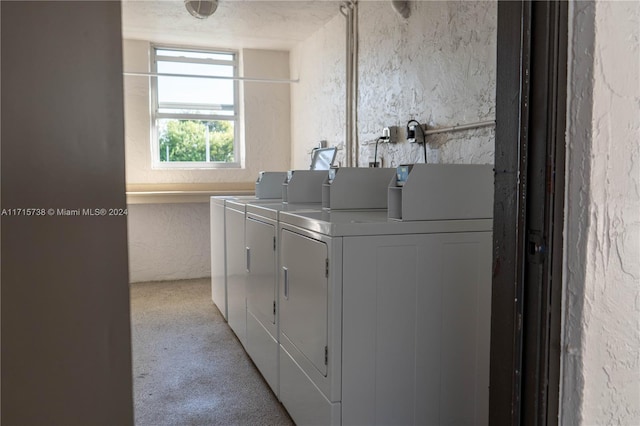 laundry area with washer and dryer and light carpet