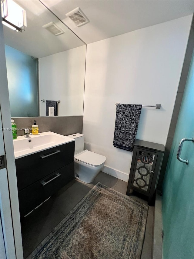 bathroom featuring vanity and toilet